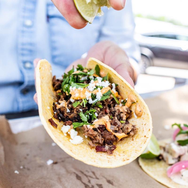 Brisket tacos topped with onions and cilantro